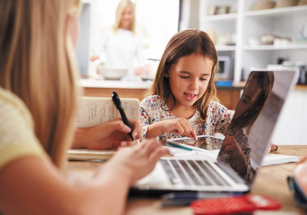 sisters-doing-homework-in-kitchen